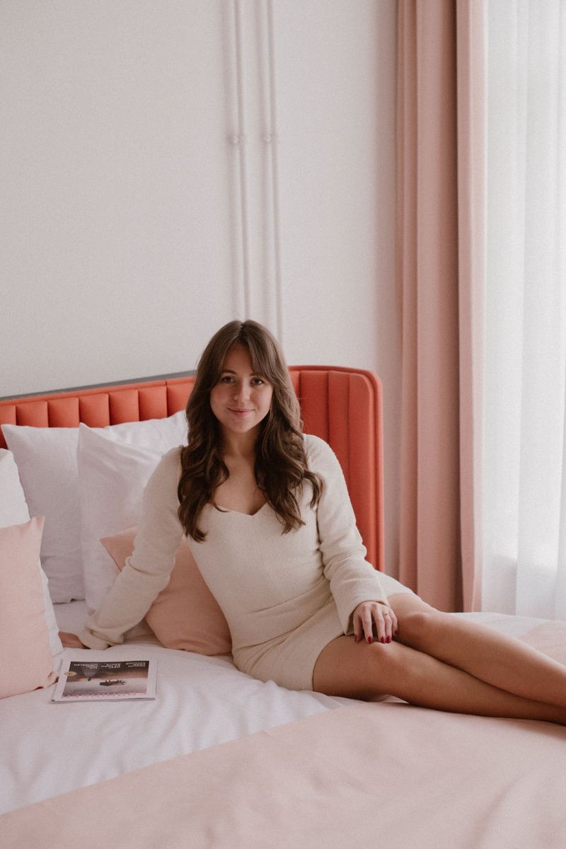 Thessa on her phone in bed, talking to her AI employee